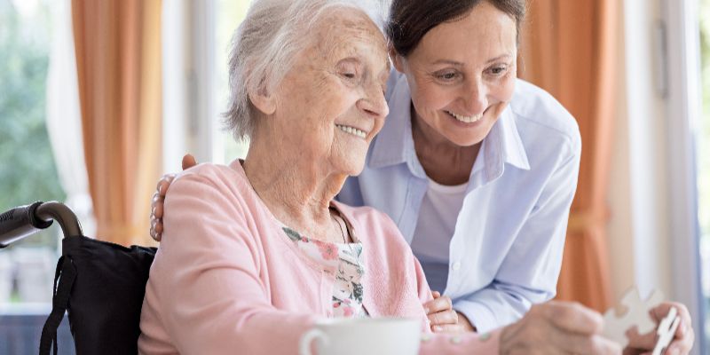 mullen residences elderly lady with caregiver landscape