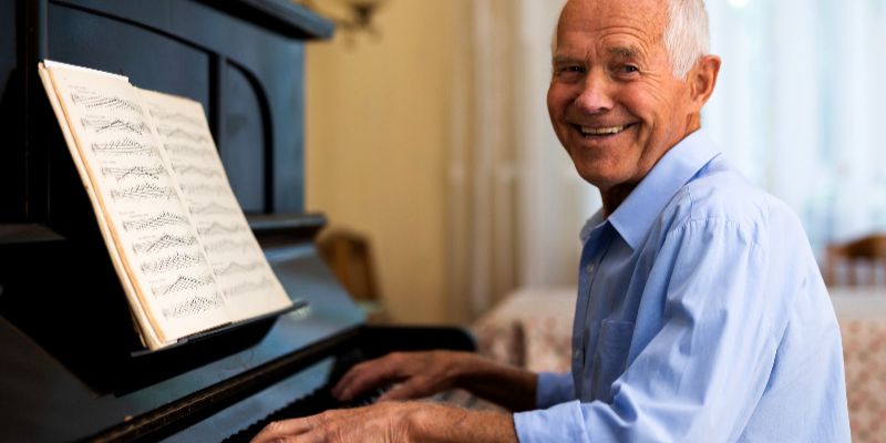 mullen residences man playing the piano landscape