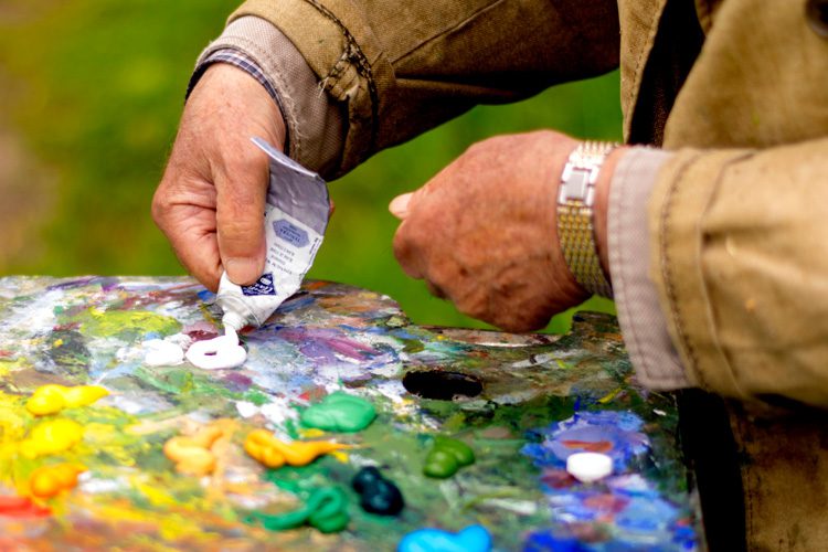 mullen residences hand squeezing tube of paint