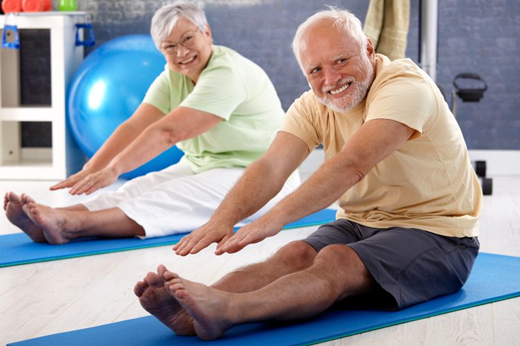 mullen residences senior couple stretching in gym