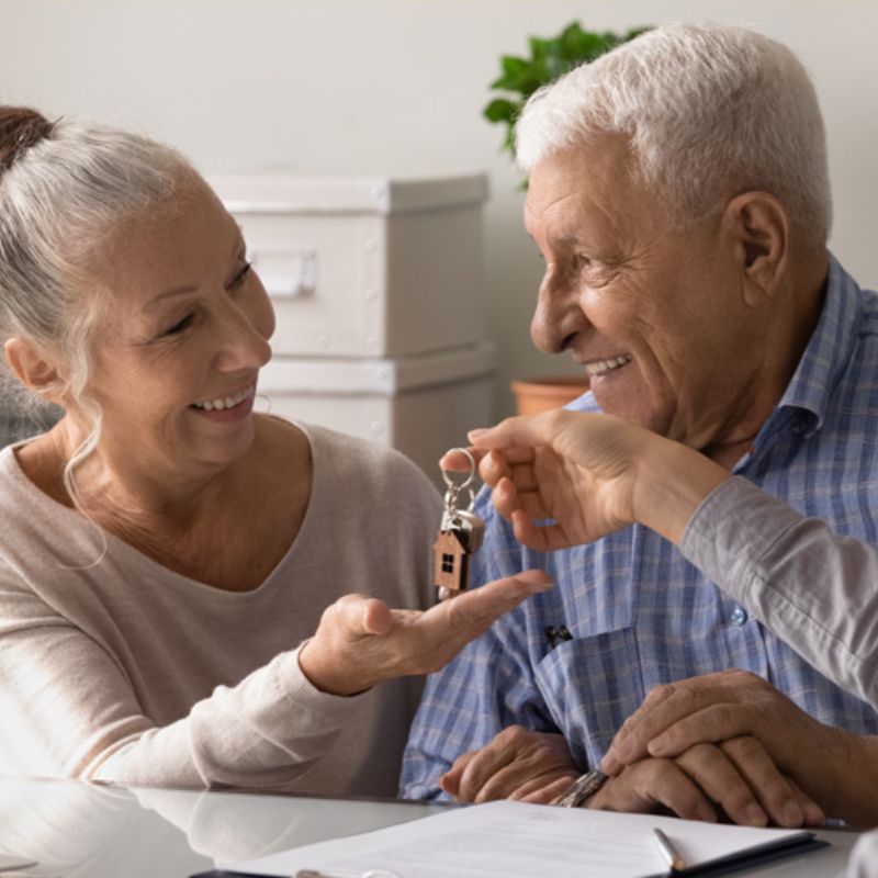 mullen residences senior couple getting new key from salesperson 1