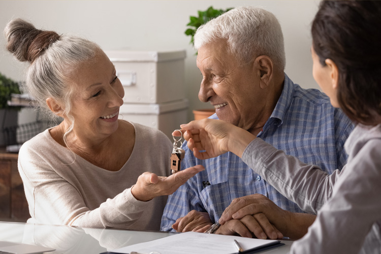 mullen residences senior couple getting new key from salesperson