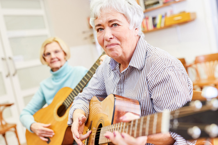 mullen residences two women playing guitar mullen residences two women playing guitar