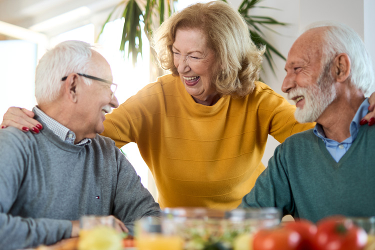 mullen residences senior adults laughing at meal time