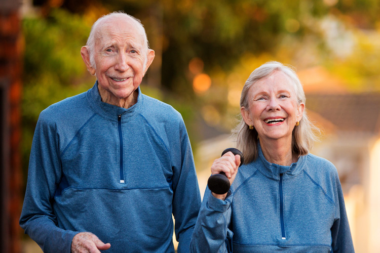 mullen residences senior couple walking outside with weights mullen residences senior couple walking outside with weights