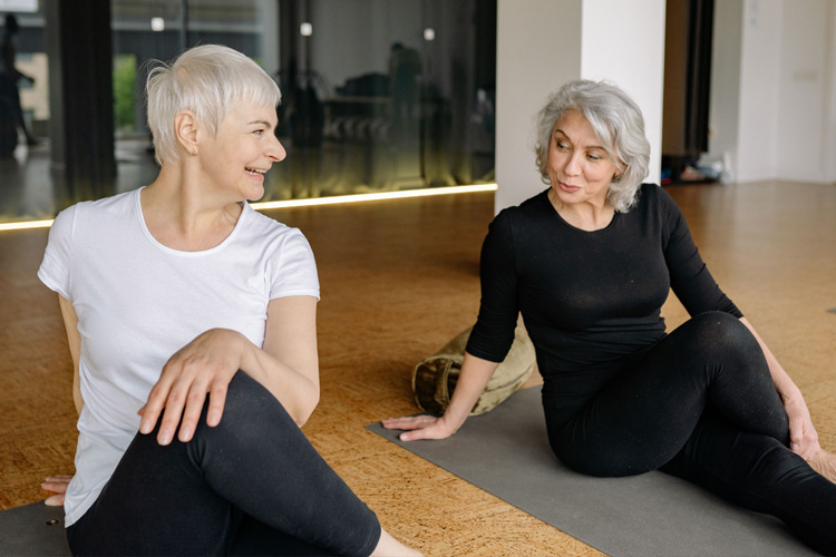 mullen residences two senior woman stretching in an exercise class mullen residences two senior woman stretching in an exercise class