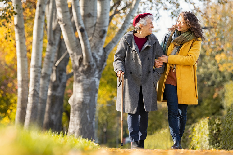 mullen residences senior woman walking outside with adult daughter